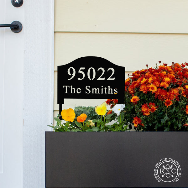 address yard sign with stake in flower box