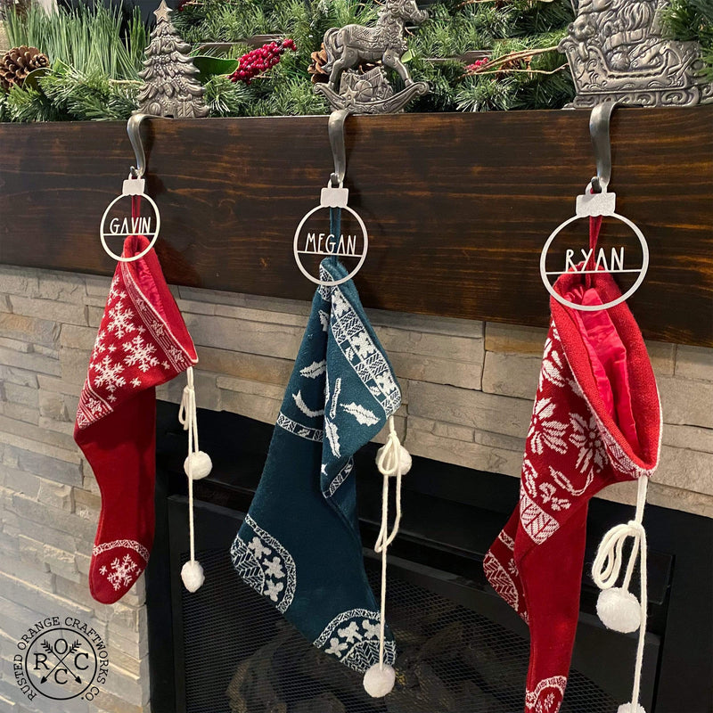 ornaments above fireplace with stockings hanging