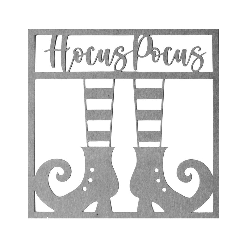 Square metal sign saying hocus pocus above pair of witch's shoes, shown against white background.