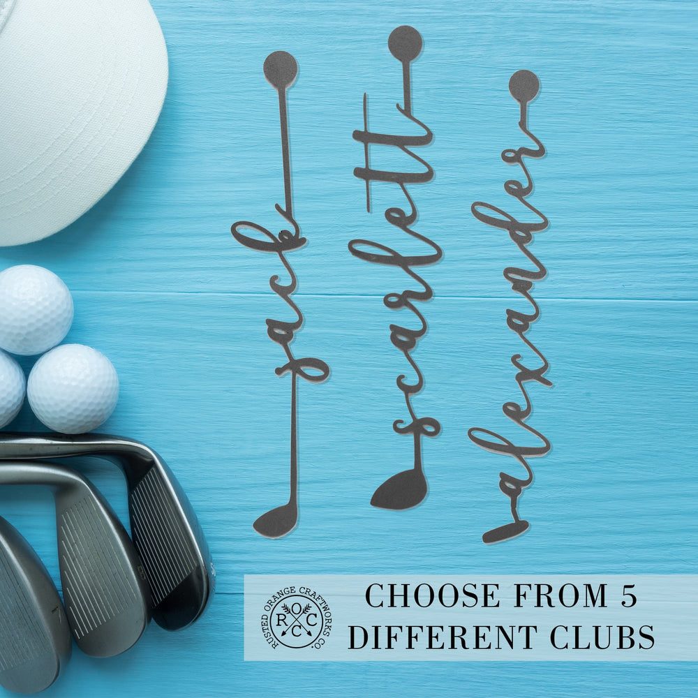 Golf club signs on table next to golf equipment