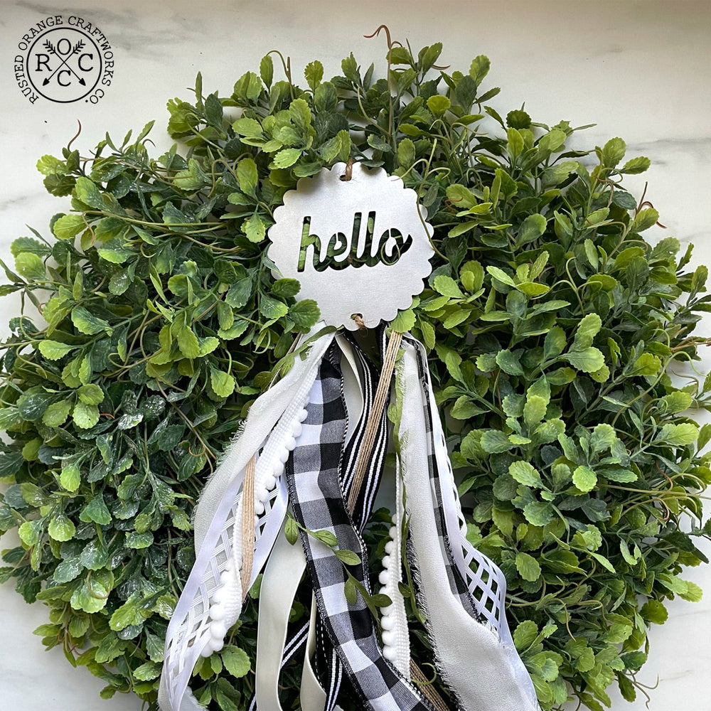 wreath badge on front door wreath hello style