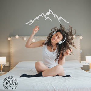 mountain metal wall art in bedroom above bed