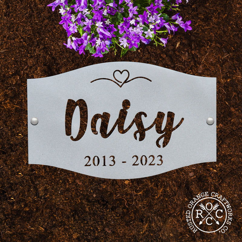 pet memorial plaque laying flat in the dirt