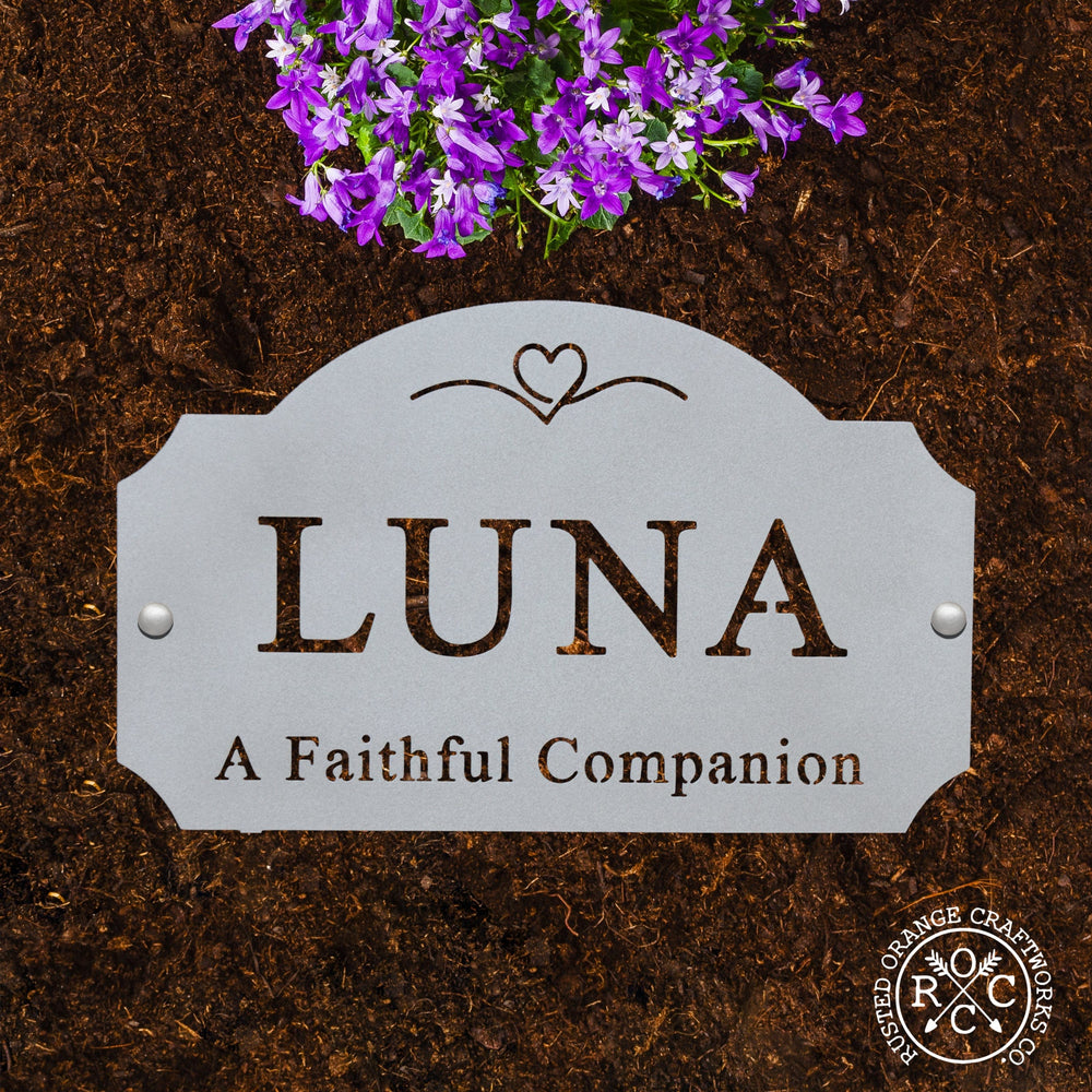 pet memorial plaque laying flat in garden