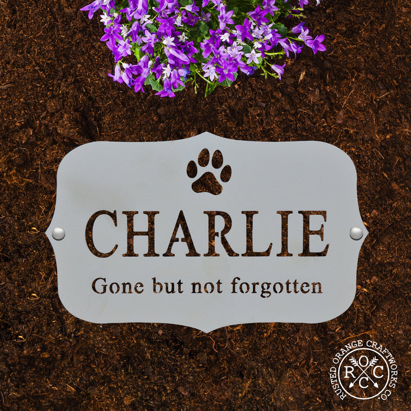 pet memorial plaque laying flat in the dirt