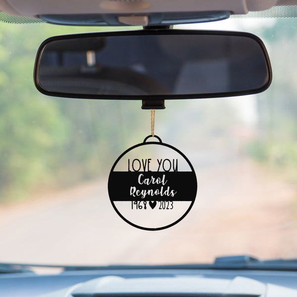 memorial ornament hanging on a car's rearview mirror