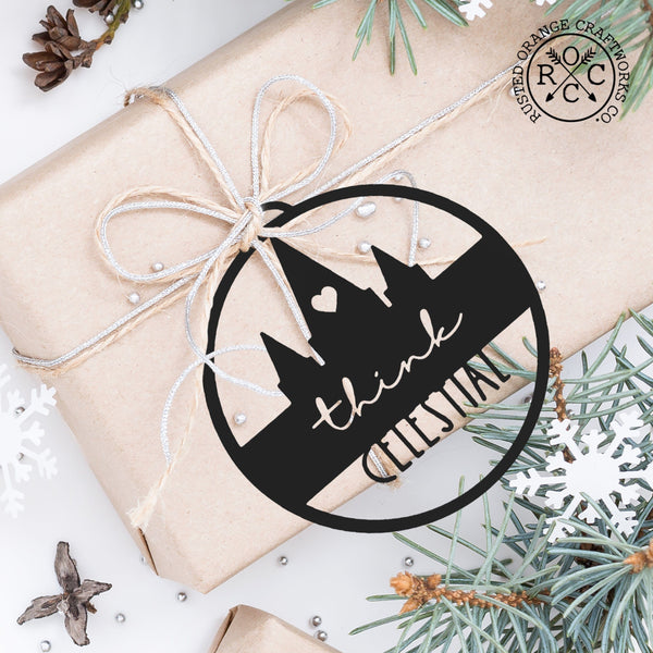 think celestial ornament powder coated in black tied to a wrapped gift