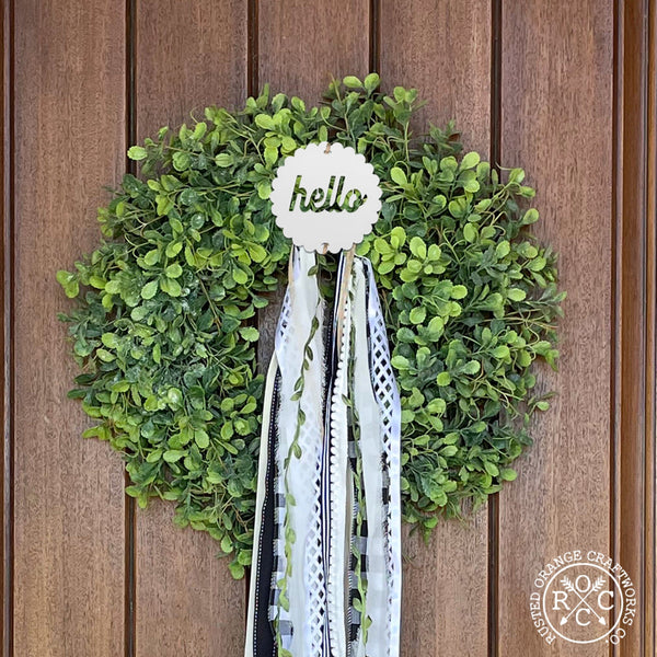 wreath badge on front door wreath hello style
