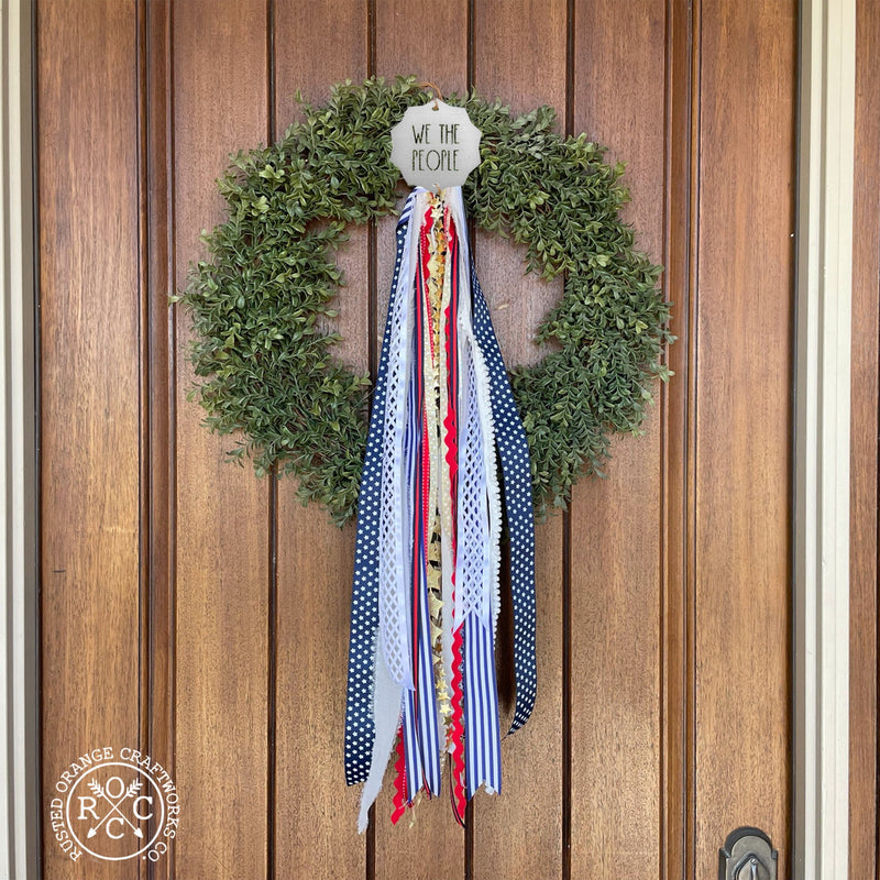 wreath badge on front door wreath we the people style