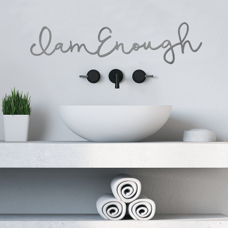 I am enough phrase sign above bathroom sink