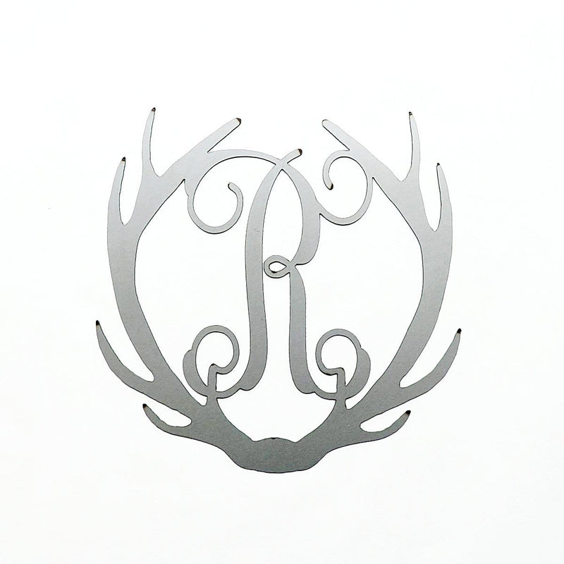 Metal deer antlers with monogram R in the middle, shown against white background.