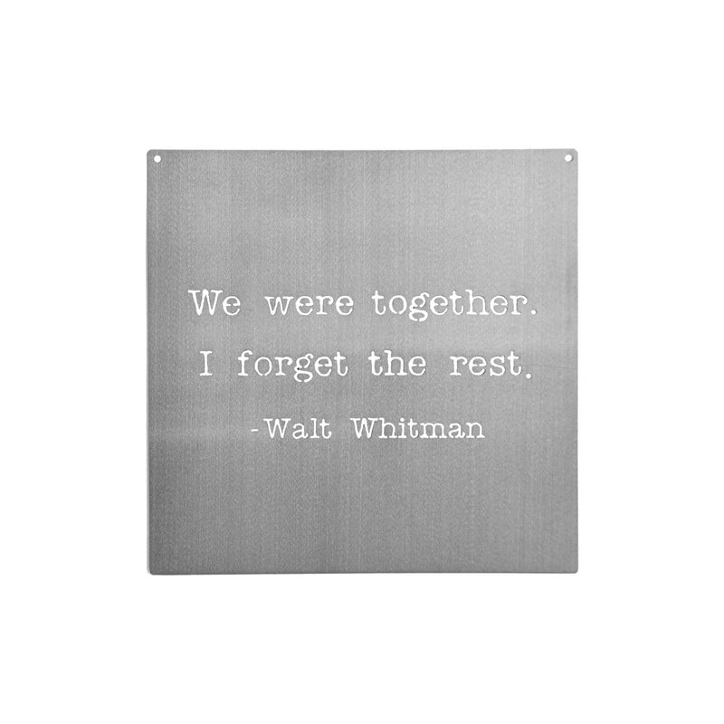 Square metal sign saying we were together. I forget the rest. Walt Whitman; shown against white background.