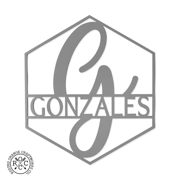 Hexagon shaped metal sign with last name and monogram in center, shown against white background.