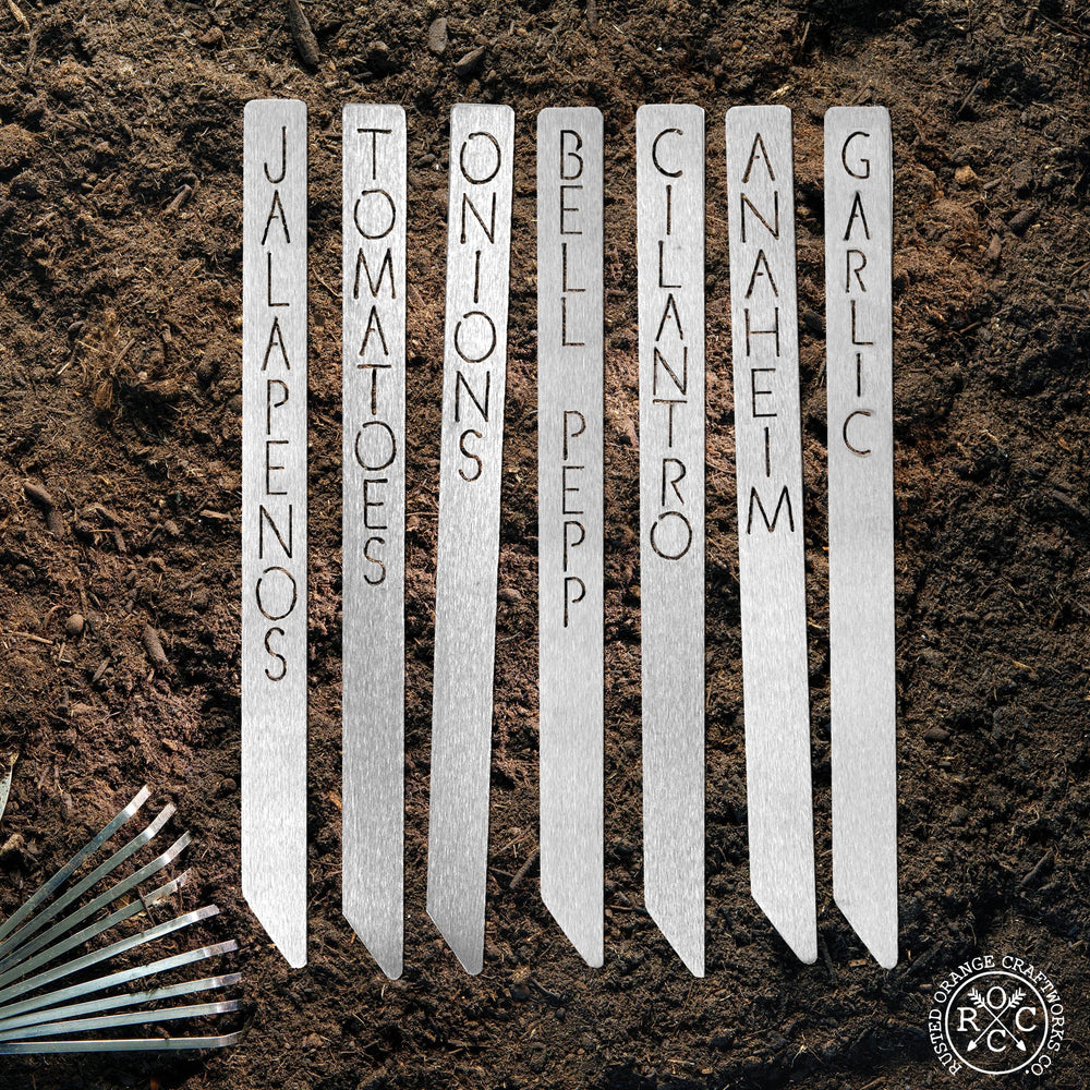 Metal garden markers in dirt