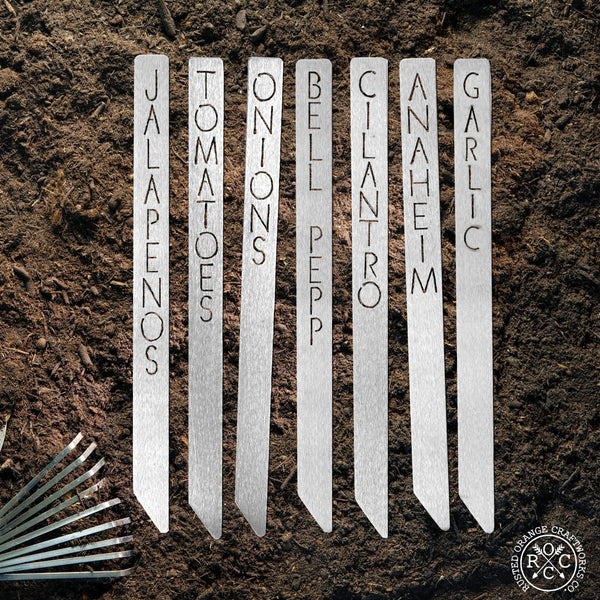 Metal garden markers in dirt