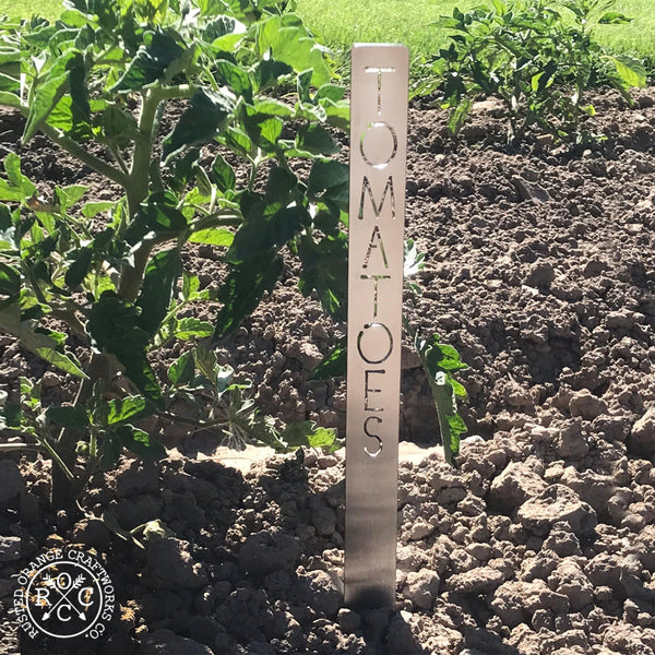 Metal garden marker staked in the dirt
