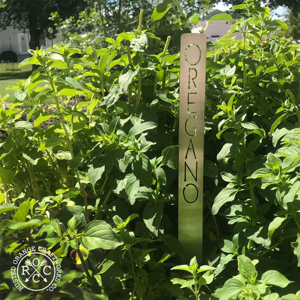 Metal garden marker in a bush