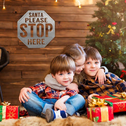 santa stop here sign on wall behind kids