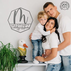 monogram on wall next to happy family