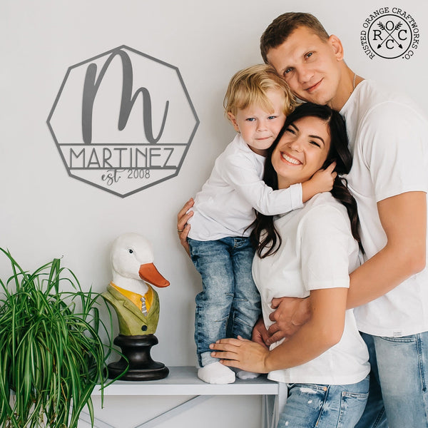 monogram on wall next to happy family
