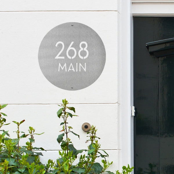 address plaque on wall next to front door