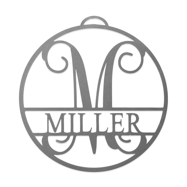 Circle metal ornament with name and monogram in center, shown against white background.