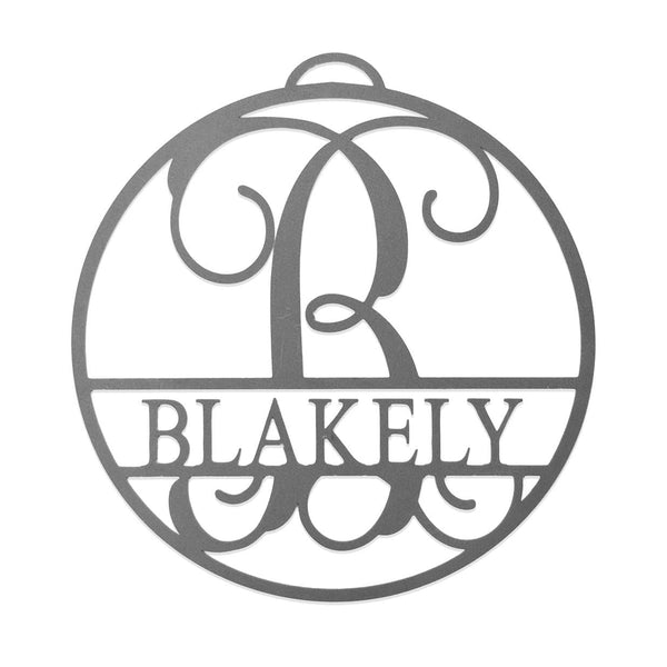 Circle metal ornament with name and monogram in center, shown against white background.