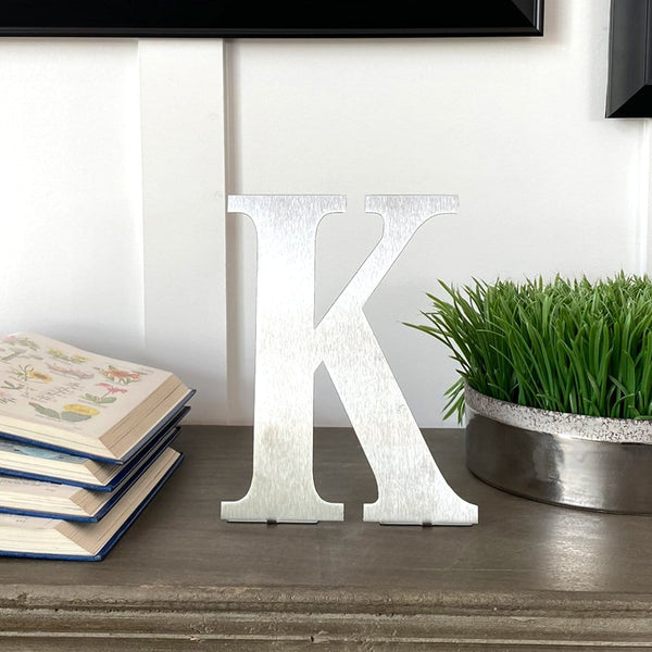 letter k standing on desk