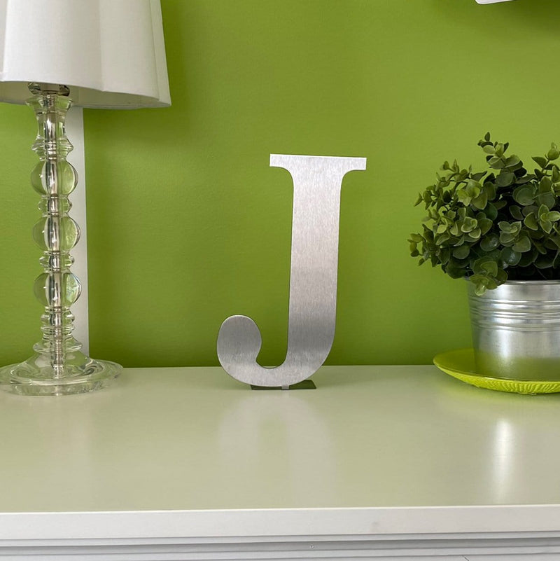 letter j standing on desk
