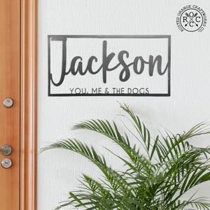 this is us name sign on wall by front door