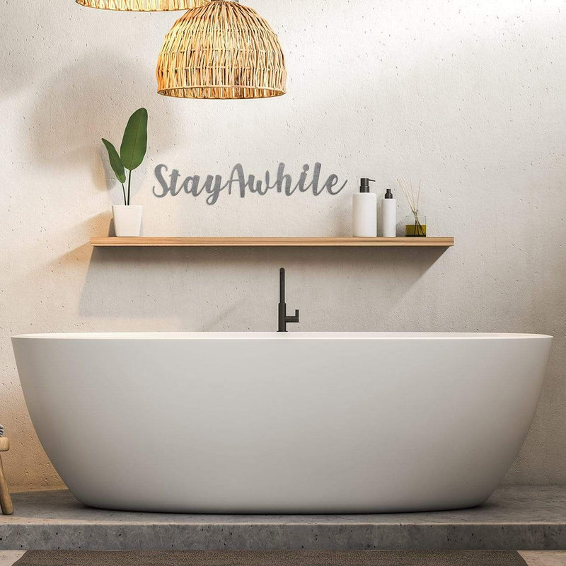 stay awhile phrase sign on wall above bathtub