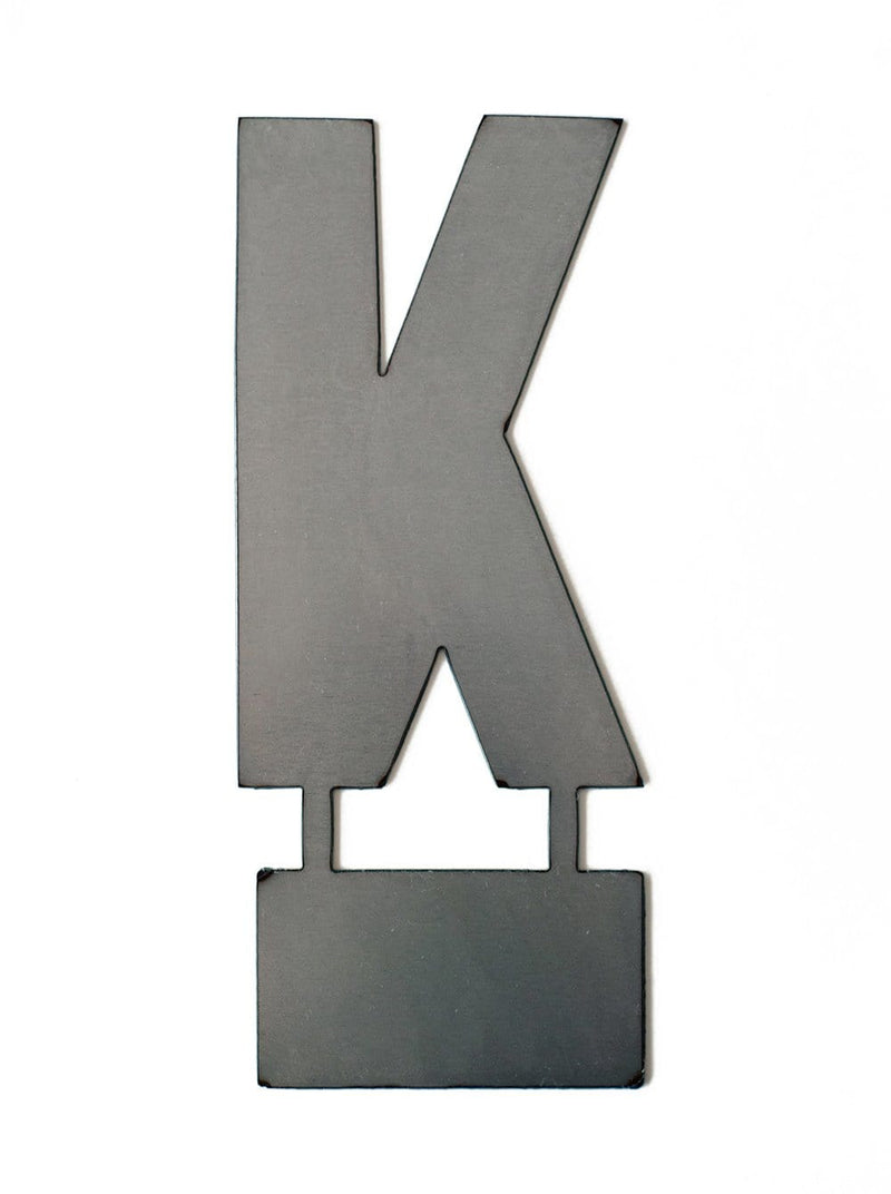Metal letter K with tab on bottom for standing, shown against white background.