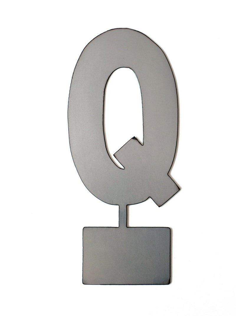 Metal letter Q with tab on bottom for standing, shown against white background.