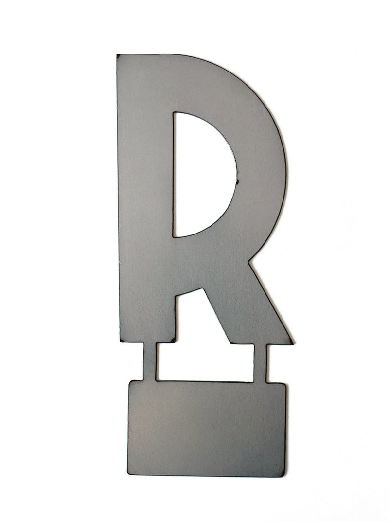 Metal letter R with tab on bottom for standing, shown against white background.