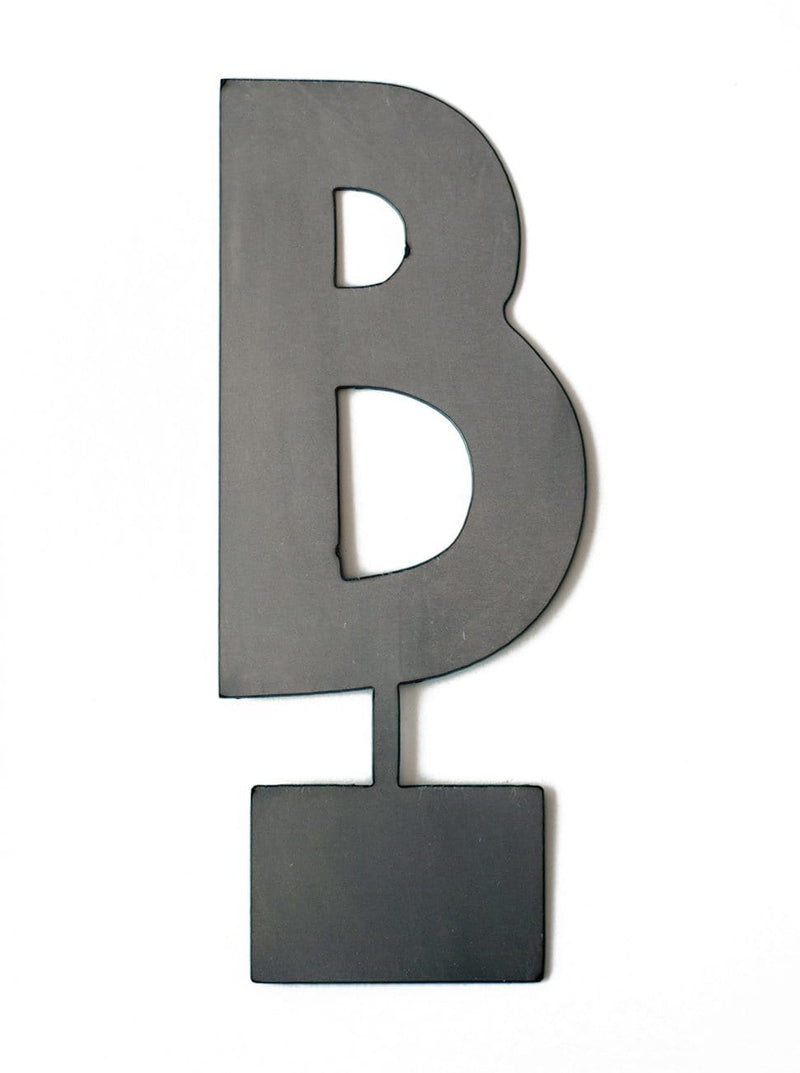 Metal letter B with tab on bottom for standing, shown against white background.