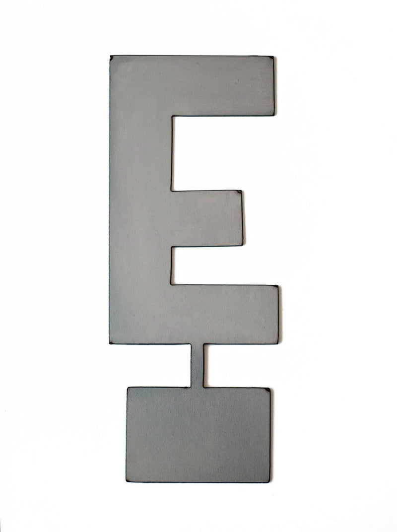 Metal letter E with tab on bottom for standing, shown against white background.