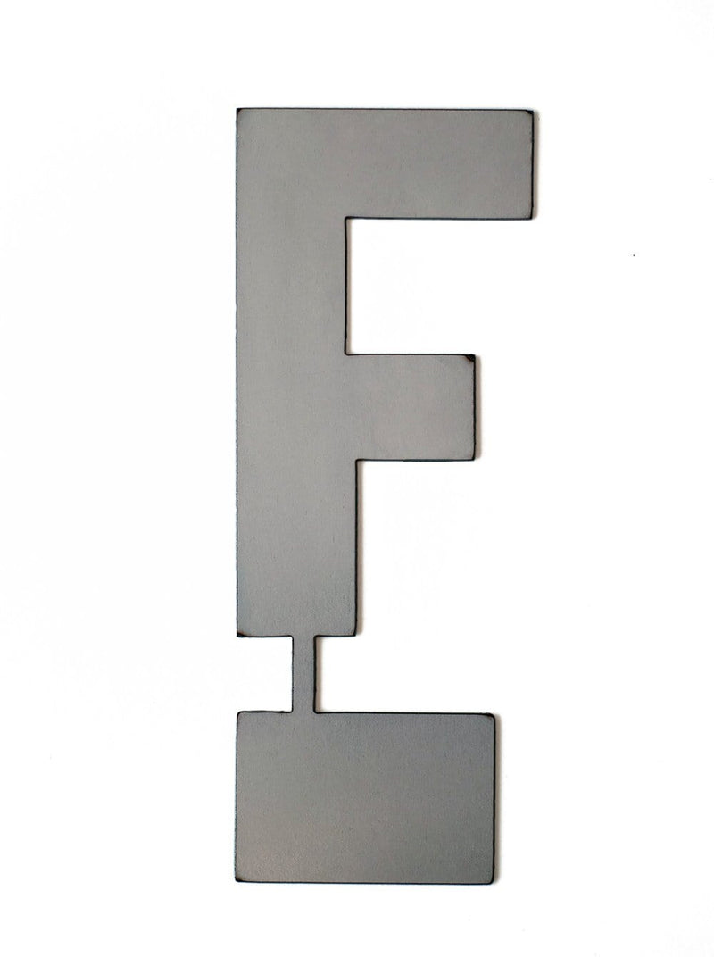 Metal letter F with tab on bottom for standing, shown against white background.