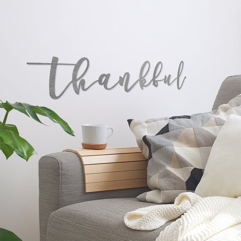 thankful sign on wall next to couch