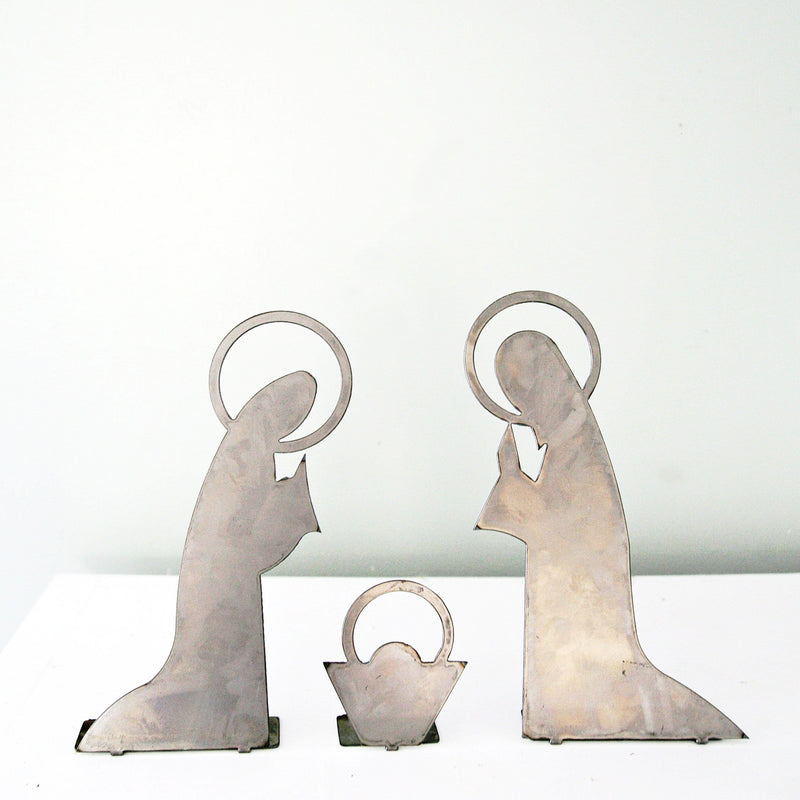 3 piece metal nativity scene silhouette standing on shelf.
