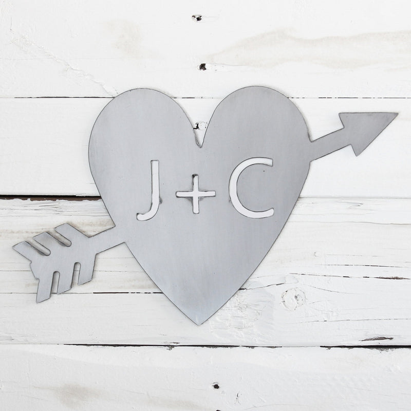 heart arrow initial sign on wooden background