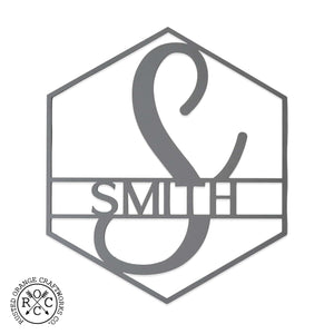 Hexagon shaped metal sign with last name and monogram in center, shown against white background.