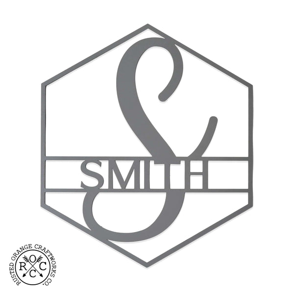 Hexagon shaped metal sign with last name and monogram in center, shown against white background.