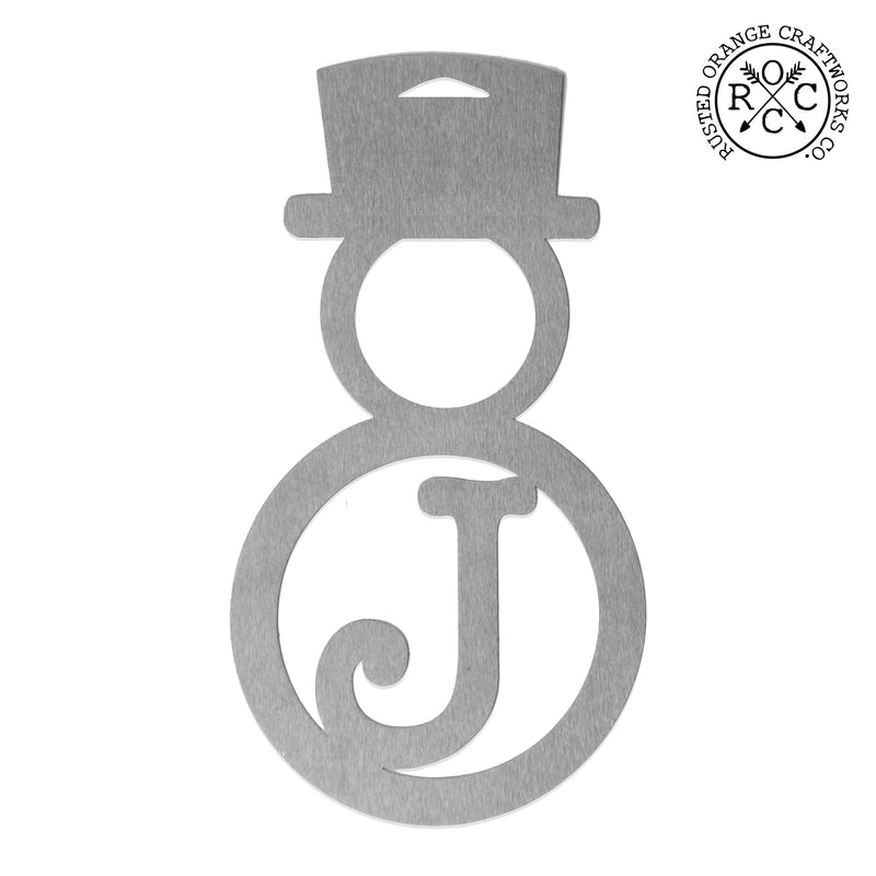 Metal snowman shaped ornament with monogram shown against white background.