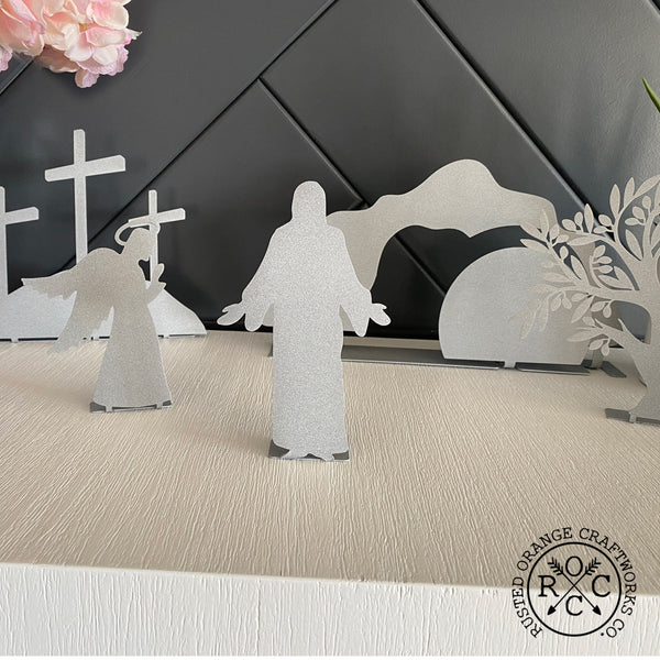 Christ, angel, crosses, and empty tomb on mantle