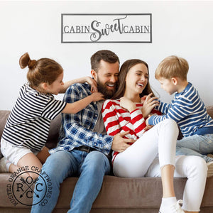 cabin sweet cabin sign above family on couch