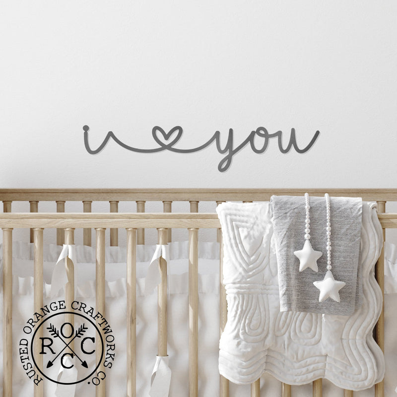 I heart you sign above baby cradle