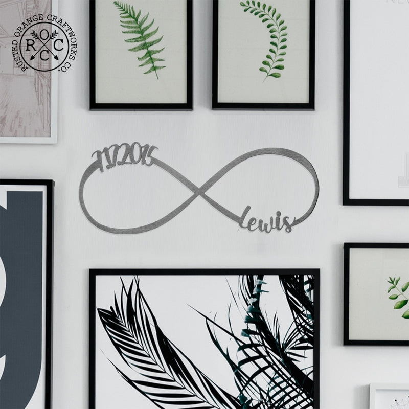 picture of metal infinity sign with 7.17.2015 and Lewis personalization hanging on gallery wall filled with picture frames