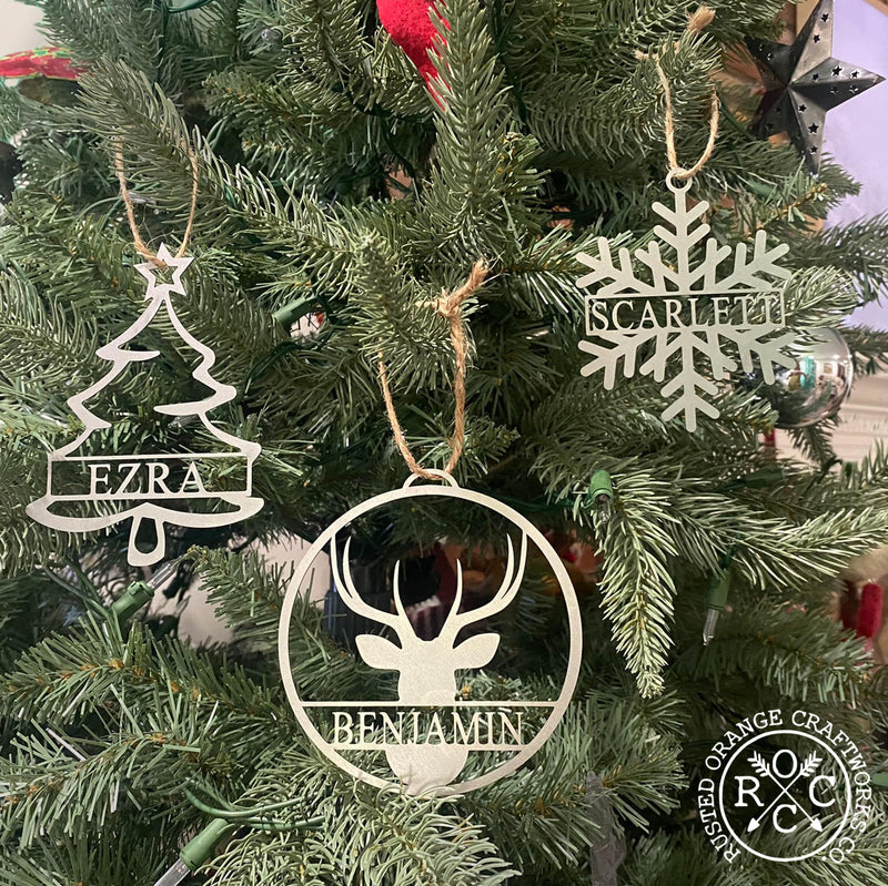 snowflake pine tree and deer ornaments on Christmas tree