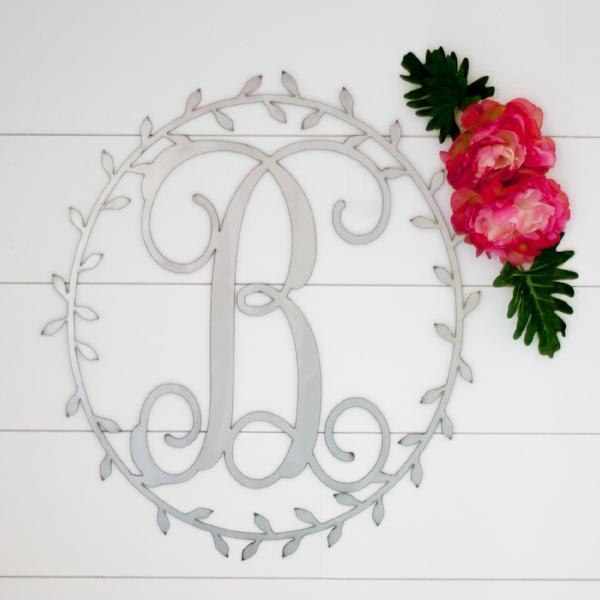 monogram on wall next to flowers