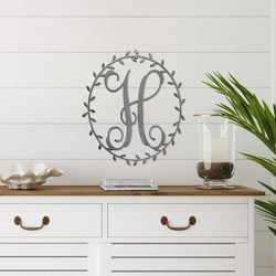 monogram on wall above dresser